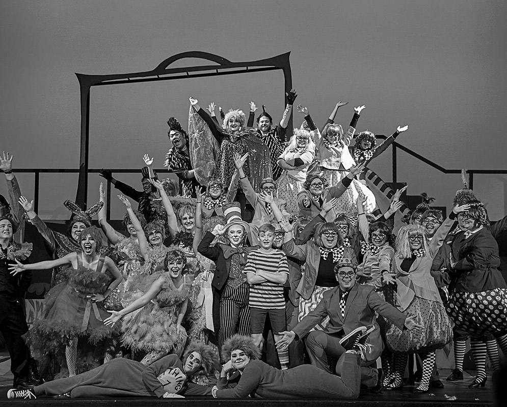 The cast of a musical posing in costume.