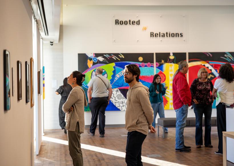 Visitors to Rooted in Relations gallery exhibition