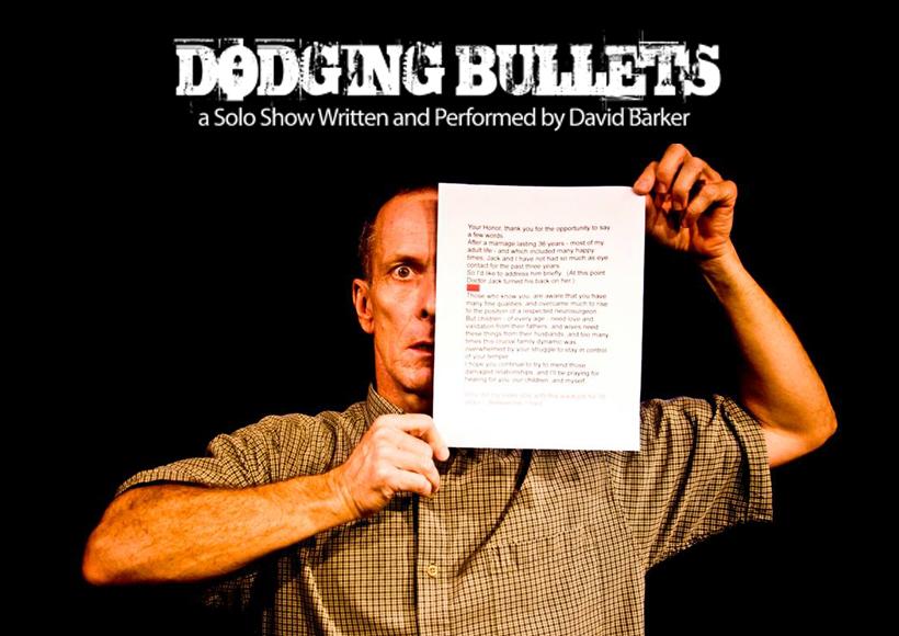 David Barker with pice of paper covering half his face