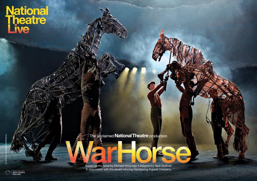 Two life sized war horse puppets on stage with five puppeteer operators on stage