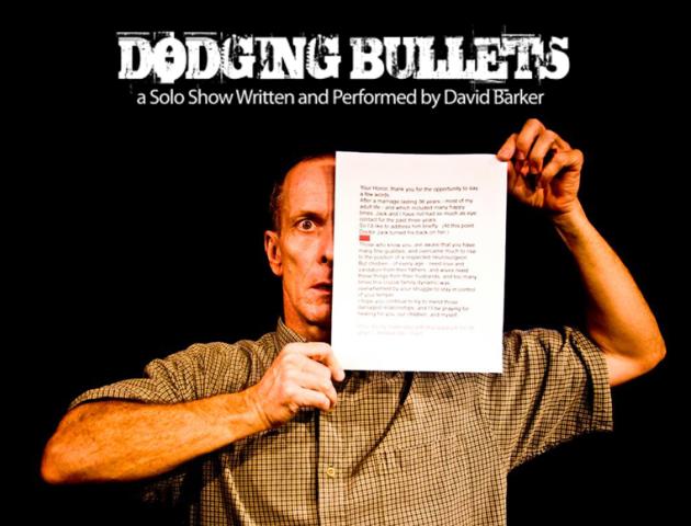 David Barker with pice of paper covering half his face