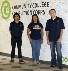 Alums in front of the signed wall
