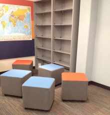 Stools are clustered together near the bookcases