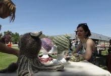 Outdoor booth features a knitted octopus.