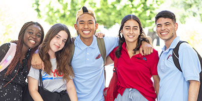 Five younger students smiling.