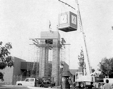 Construction of clock tower. Lift placing clock unit on top of block structure