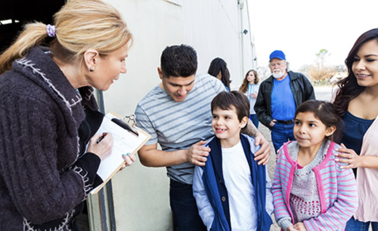 woman talking to group of children outside