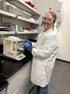 Christine Boyer in a lab coat and goggles.