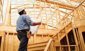 person wearing hard hat a construction framing site