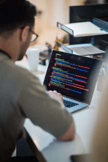 Man sitting at a desk in front of a laptop