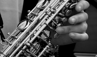 A close up of a saxophone in a hand