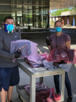 MCC employees donned masks and gloves to distribute loaner laptops and iPads to students.
