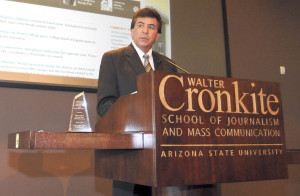 Tom Arviso standing at a podium