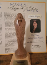 Wooden carving/award, along with program from presentation.