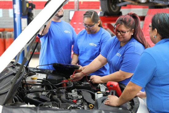 Students using diagnostic tools on Subaru Outback engine