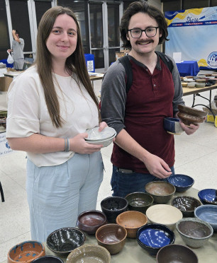 Marie-Catherine Smith and Bryton Smith picking out ceramic bowls.