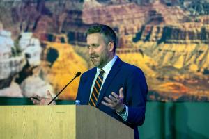 Ian Schwartz standing at podium at All-Arizona event