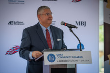 Dr. Richard Daniel addresses crowd from the podium during MCC's Workforce Development Corridor Groundbreaking ceremony.
