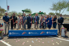 Elected leaders with college leadership and employees pose for ceremonial ground breaking with golden shovels.