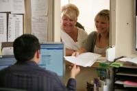 Two women at enrollment desk