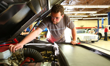 man working on car engine