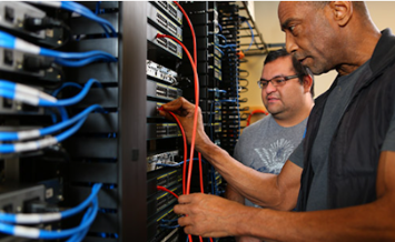 two men working on computer switches