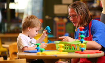 Teacher and child working with blocks