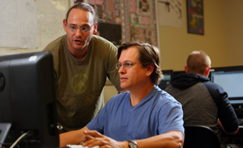 two people using computer in classroom