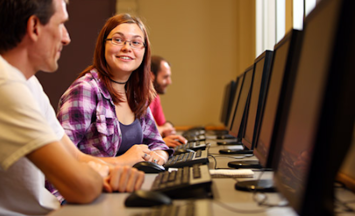 two people in computer lab talking