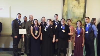 Eleven PTK members wearing medals.