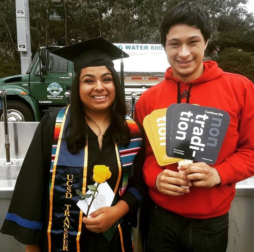 Karina Aguilar posing in her cap and gown with a friend