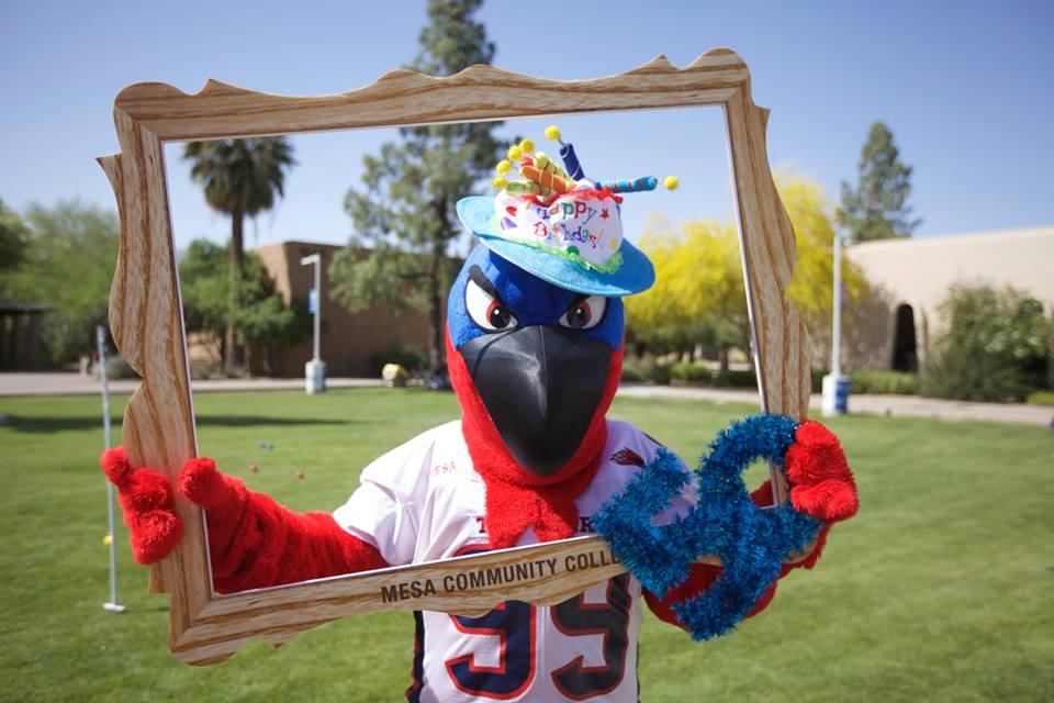Thor the Thunderbird posing behind empty picture frame for 50th anniversary