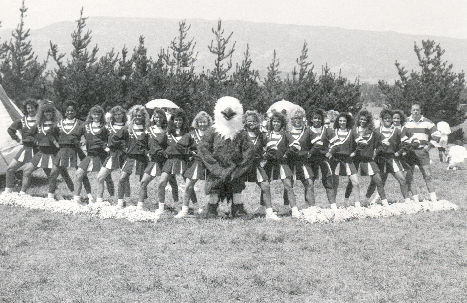 Thor the Thunderbird posing with cheerleaders, black and white image