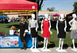 Alumni board members pose with mannequins at Dress for Success booth