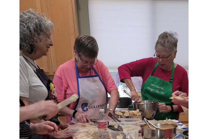 Women making tamales at a New Frontiers for Lifelong Learning event. 