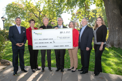 Six individuals holding a very large replica of a check for $40,000 from TruWest Credit Union made out to MCC. Individuals are, left to right: Marcy Snitzer, Dr. Lori Berquam from MCC; Alan Althouse, President/CEO, TruWest Credit Union, Melissa Carpenter, MCC; Gary Bernard, Executive Vice President & COO and Jennifer Kimmell, Senior Vice President & CMOTruWest Credit Union.  