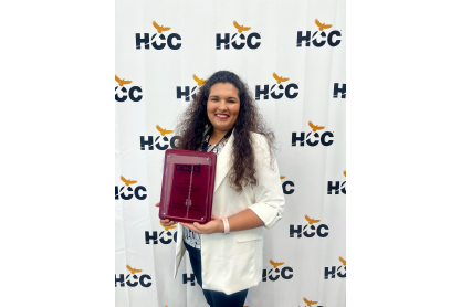 Patricia Herrera holding the Terry O'Banion award, a plaque from NCSD.
