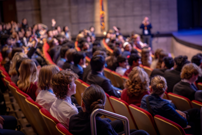 Large group of high school students in theatre style seating. 