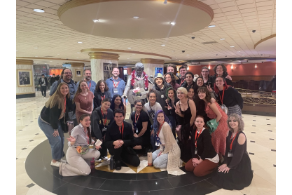 MCC students gathered around a statue of Elvis playing a guitar while attending an arts festival in Las Vegas. 