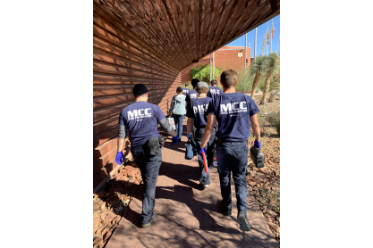 The back of MCC EMS students walking away. Their blue t-shirts clearly state MCC on the back. 