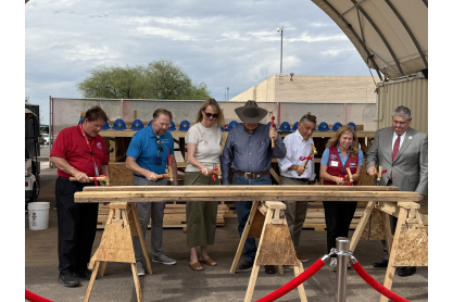 Key Construction Trades supporters participating in a golden hammer activity following remarks. 
