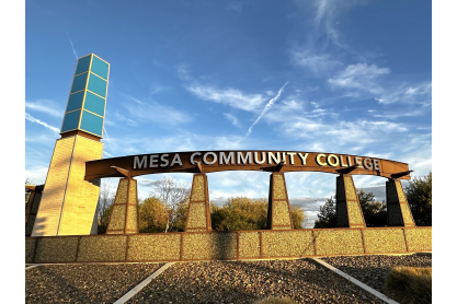 Monument sign reading Mesa Community College with a slightly clouded sky in the background. 