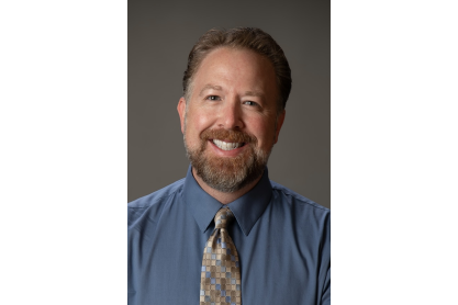 Michael Voss in dress shirt and tie. 