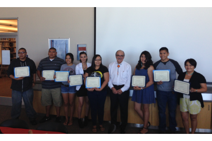 A group of people holding certificates.
