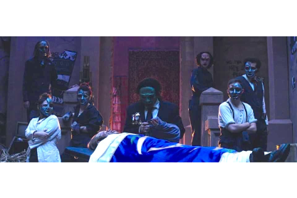 Antigone scene with multiple actors wearing masks similar to those worn during ancient Greek performances. 