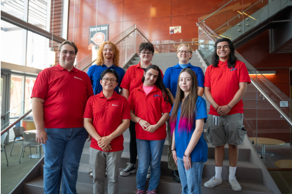 Eight members of student government posing on a staircase.