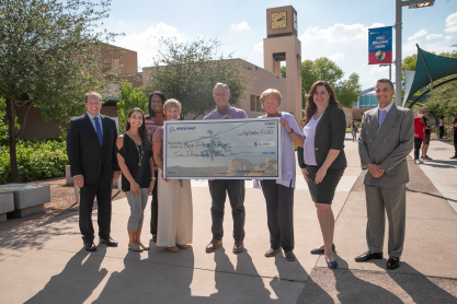 Mark Gaspers, Leann Shaffer, Pamela Hennard, Trina Medley from The Boeing Company, Mesa  Mayor John Giles, and Dr. Lori Berquam, Carmen Newland and Christos Chronis from MCC behind an oversized check from The Boeing Company.  