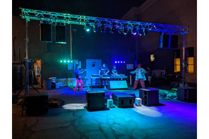 Stage with bright blue lights and DJs dancing