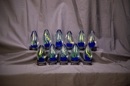 Several egg-shaped glass trophies. 