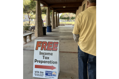 Sign reading: Free income tax preparation with a directional arrow. 